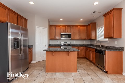 A kitchen with wooden cabinets and a granite countertop.