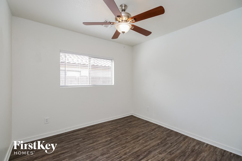 a living room with a ceiling fan and a window