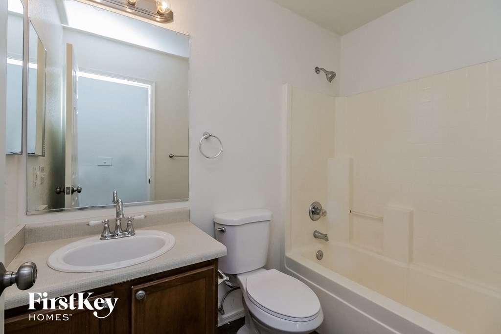 a bathroom with a sink toilet and a tub