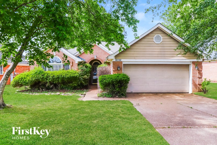 a home with a driveway and a garage door