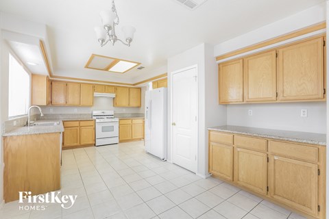 A kitchen with wooden cabinets and a white refrigerator.