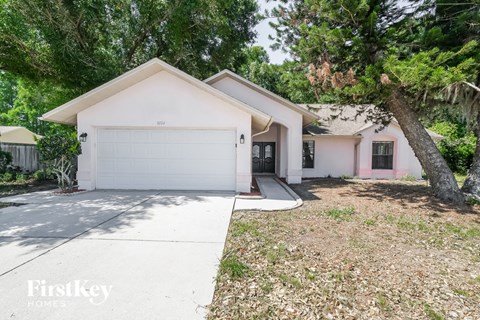 A house with a white garage door is for sale.