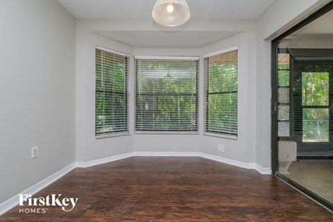 A room with wooden floors and a sliding glass door.