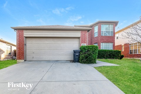 a garage door in front of a brick house