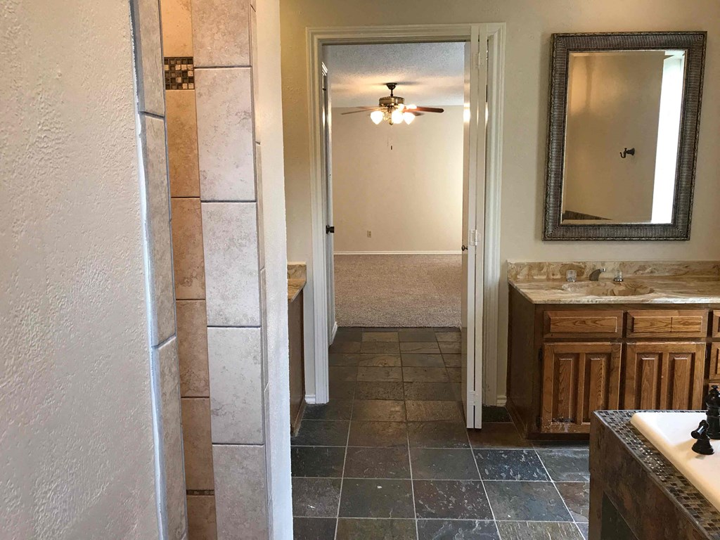 a bathroom with a sink and a ceiling fan