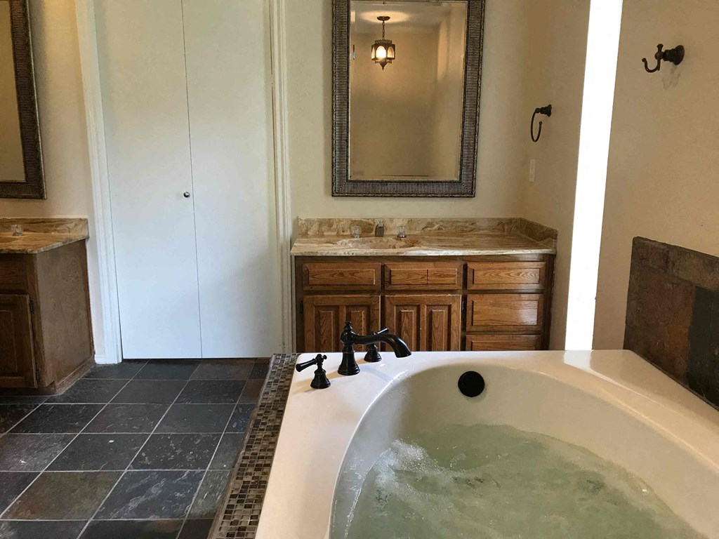 a large jacuzzi tub in a bathroom with a sink