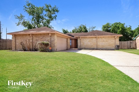 a home with a lawn and a garage and a driveway