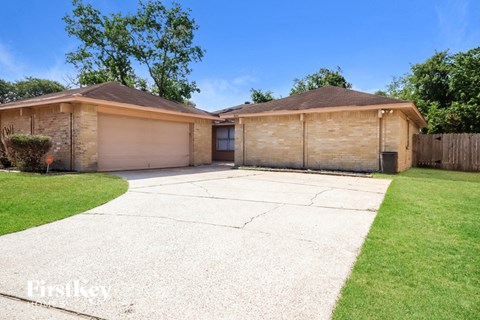 a home with two garages and a driveway