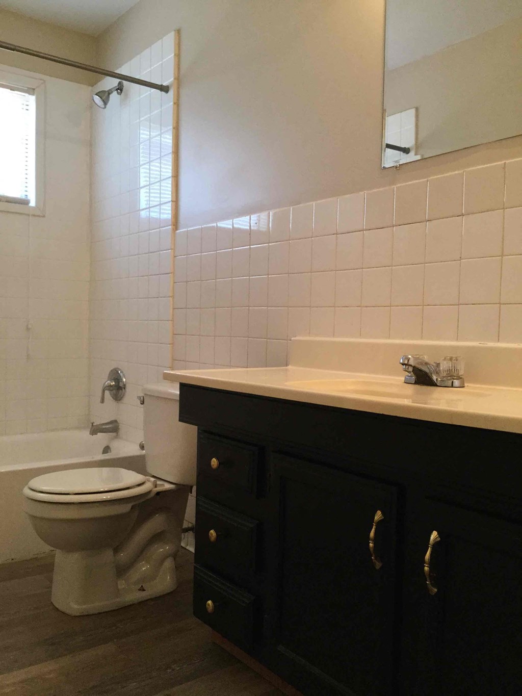 A white toilet sits next to a sink in a bathroom.
