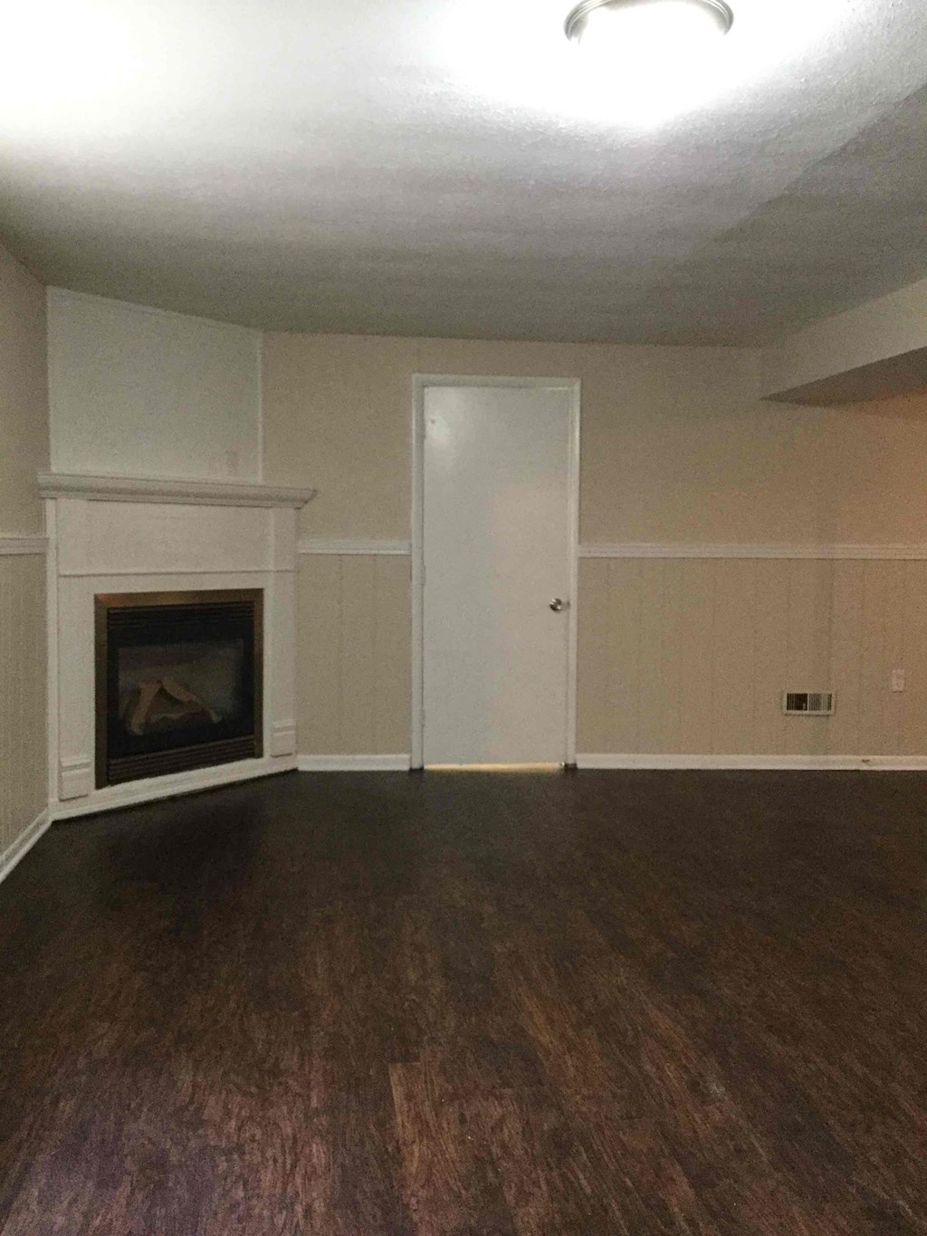 A room with a fireplace and a door.