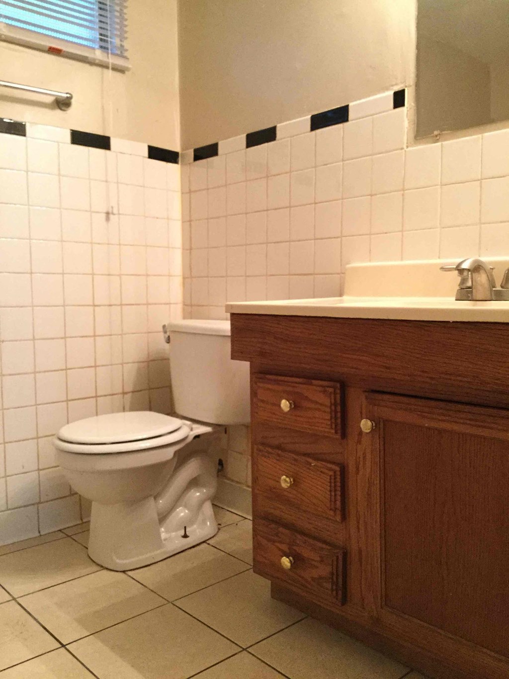 A white toilet sits next to a sink in a bathroom.