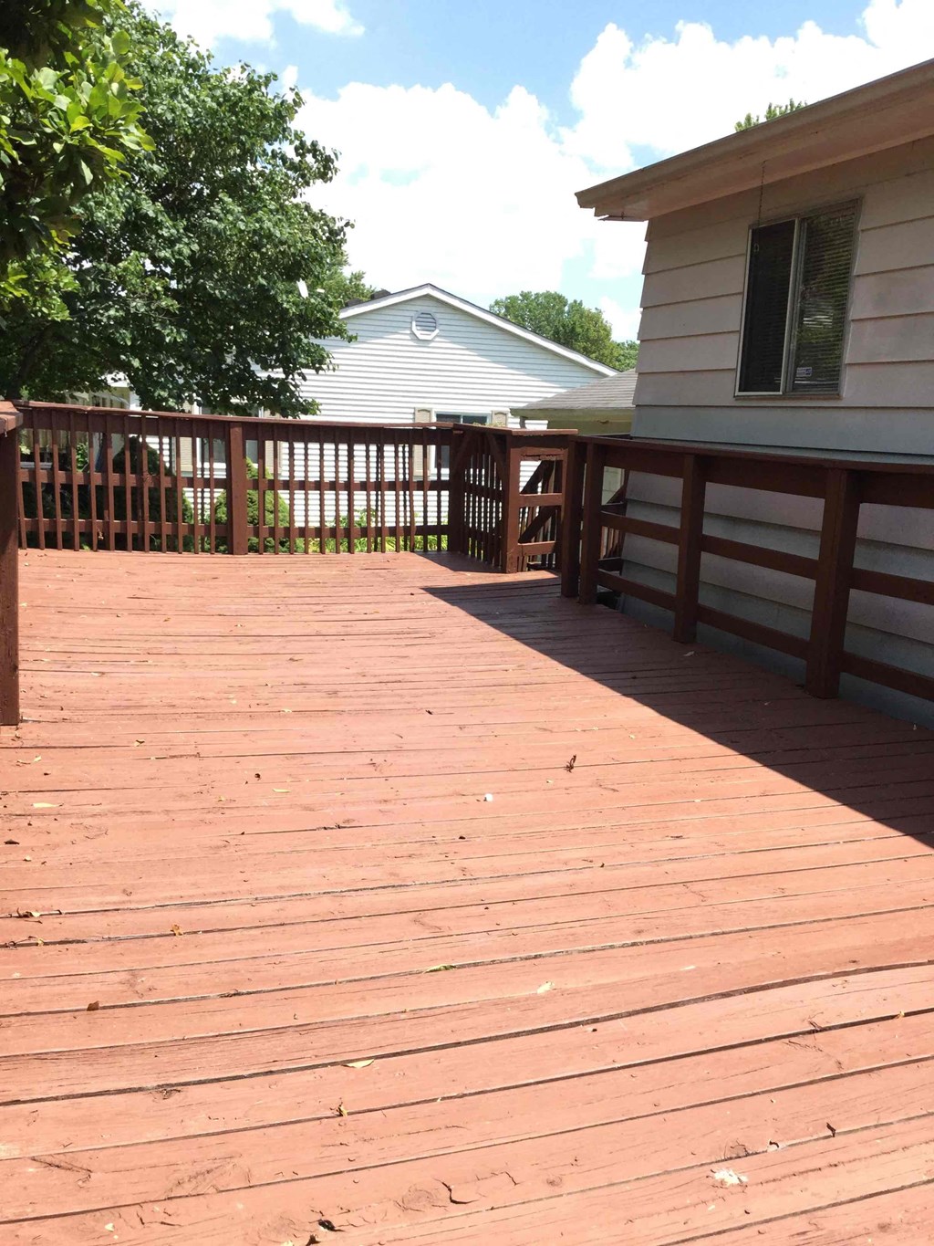 A wooden deck leads to a house.
