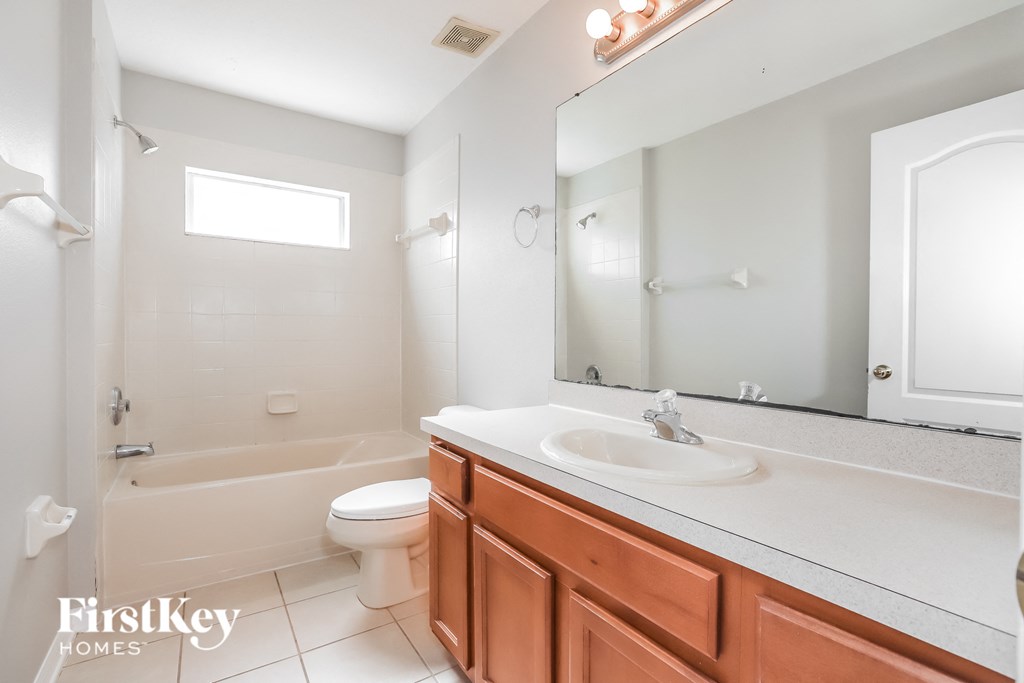 a bathroom with a sink toilet and a mirror