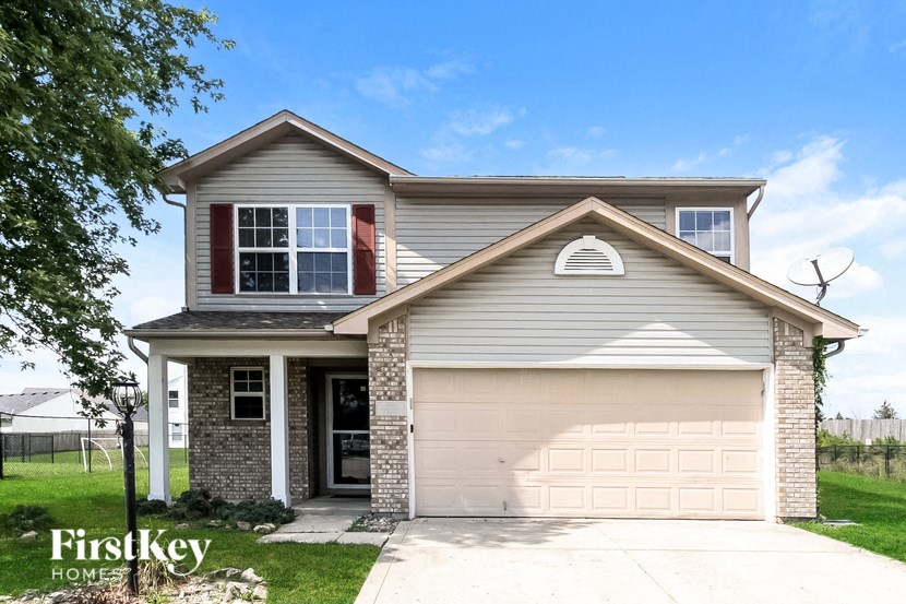 a house with a garage door and a lawn