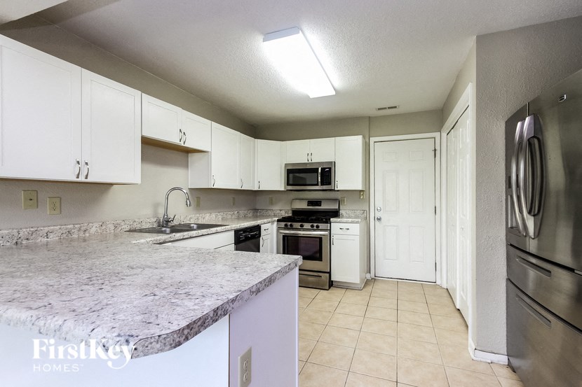 a kitchen with granite counter tops and stainless steel appliances