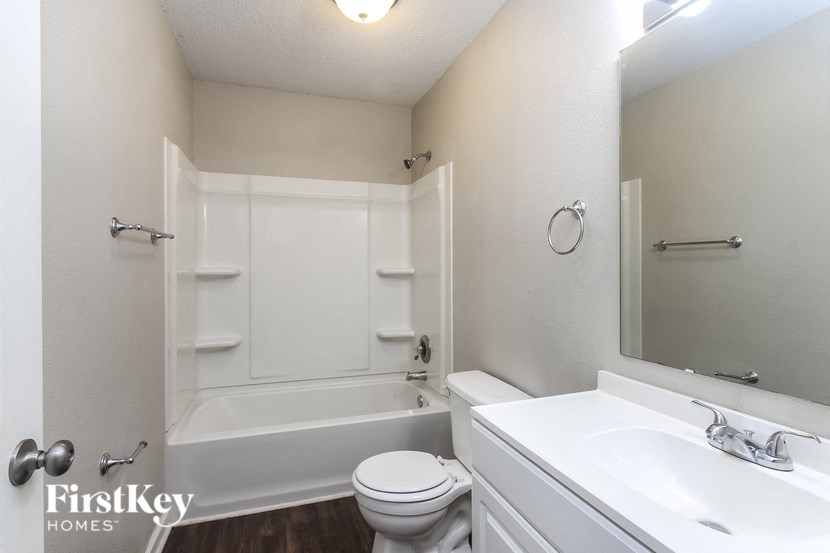 a bathroom with a sink toilet and a bath tub