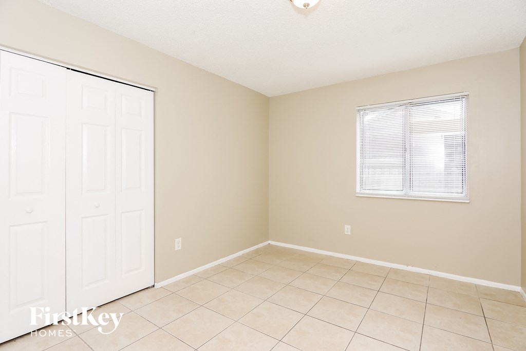a room with a tiled floor and a white door