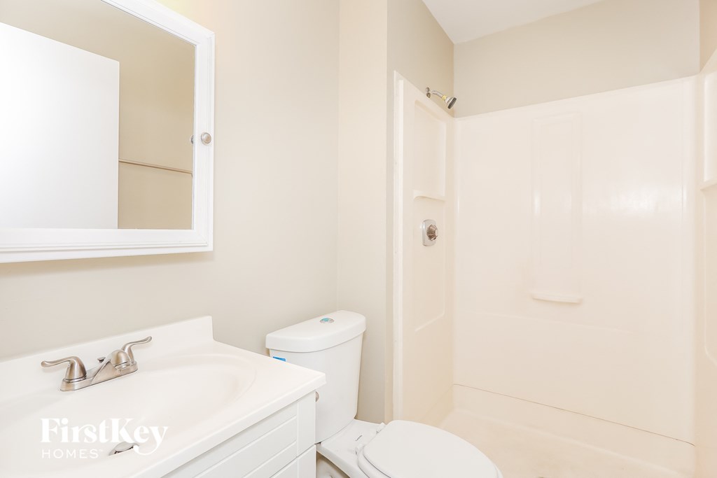 a bathroom with a sink toilet and a shower
