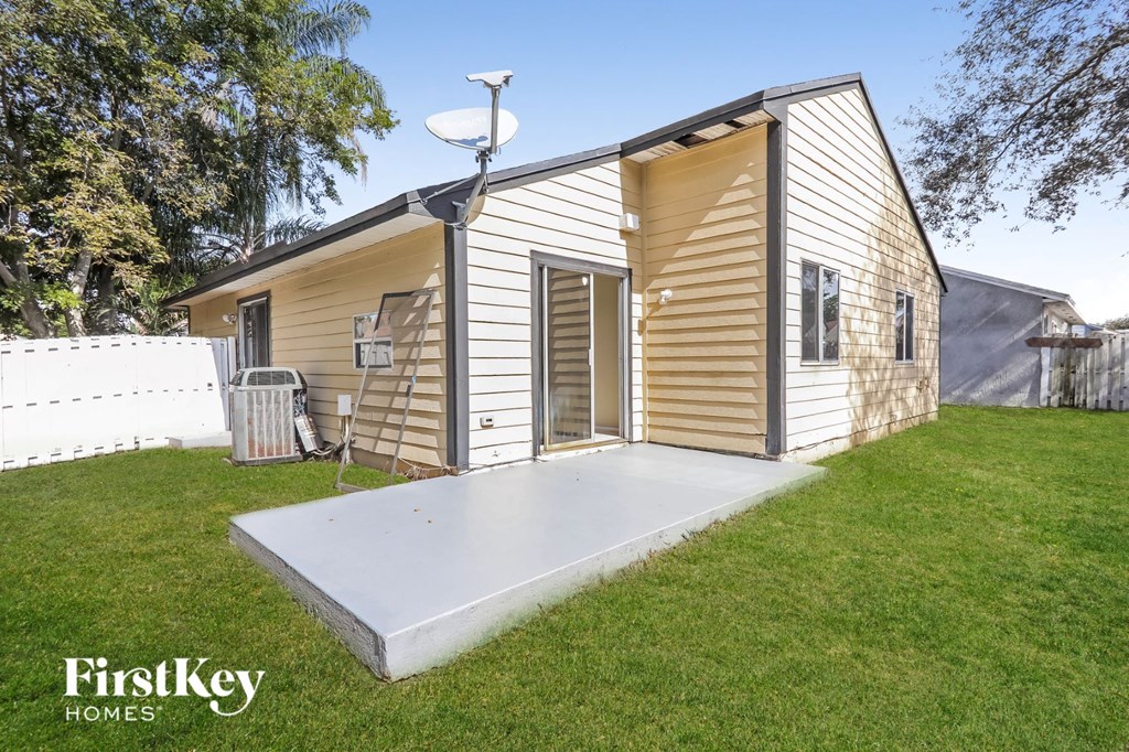 a tiny house with a porch and a lawn