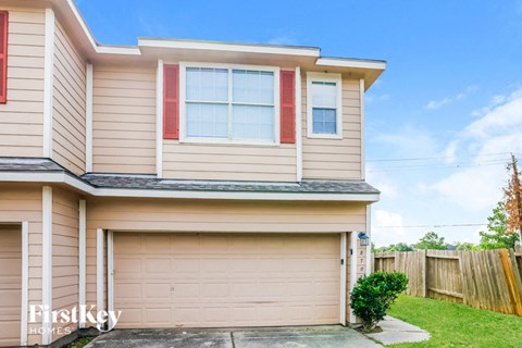 a house with a garage door and a lawn