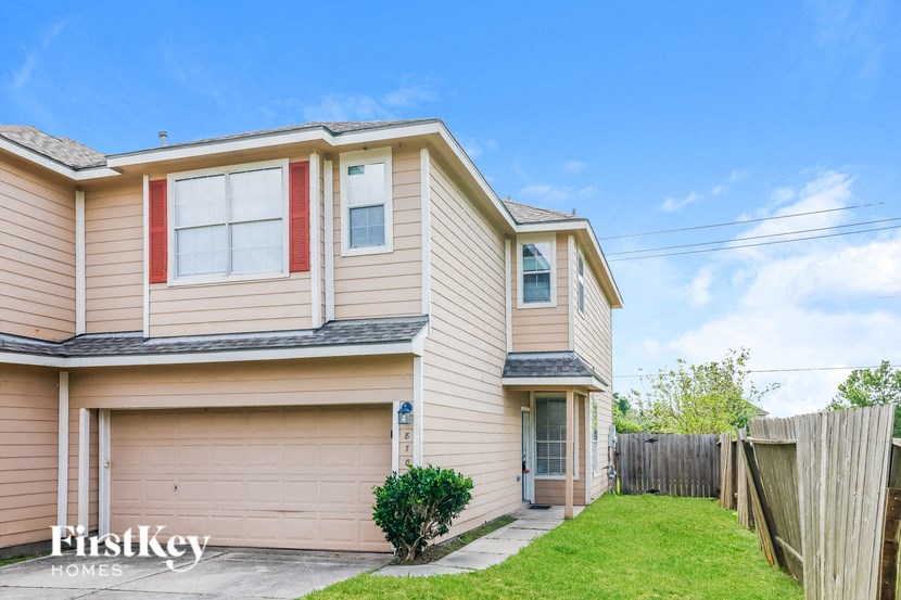 a tan and with a yard and a fence