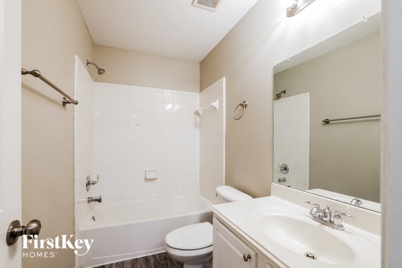 a bathroom with a sink toilet and a tub