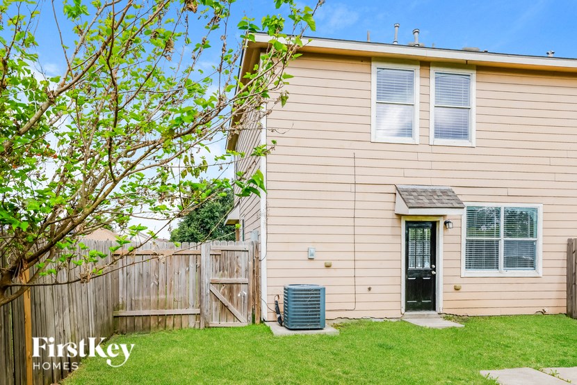 a house with a yard and a wooden fence