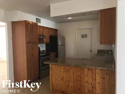 a kitchen with a counter top and a refrigerator