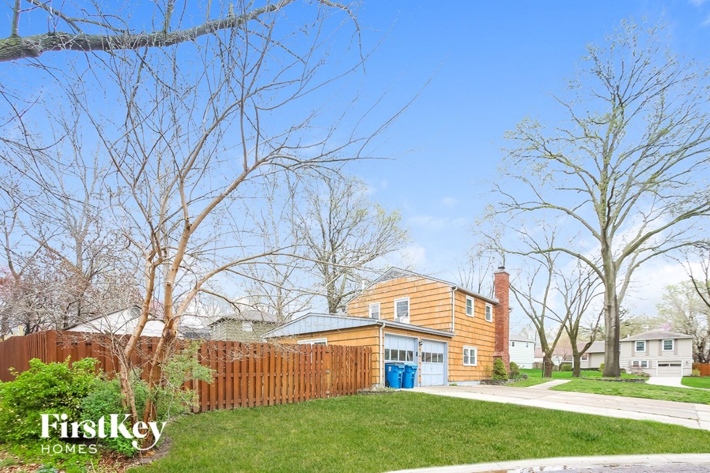 a backyard with a wooden fence and a house