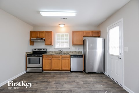 A kitchen with wooden cabinets and stainless steel appliances.