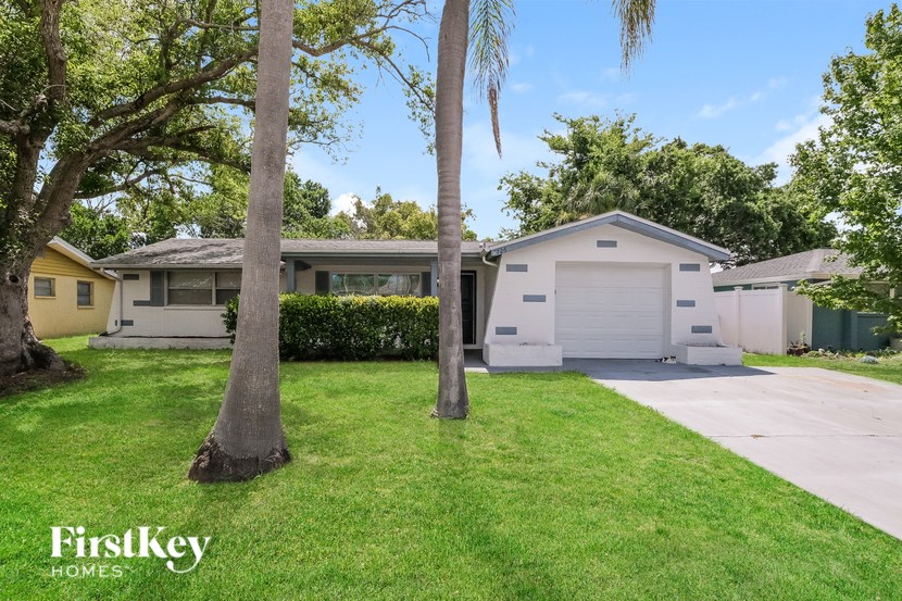 A house with a white garage door is for sale.