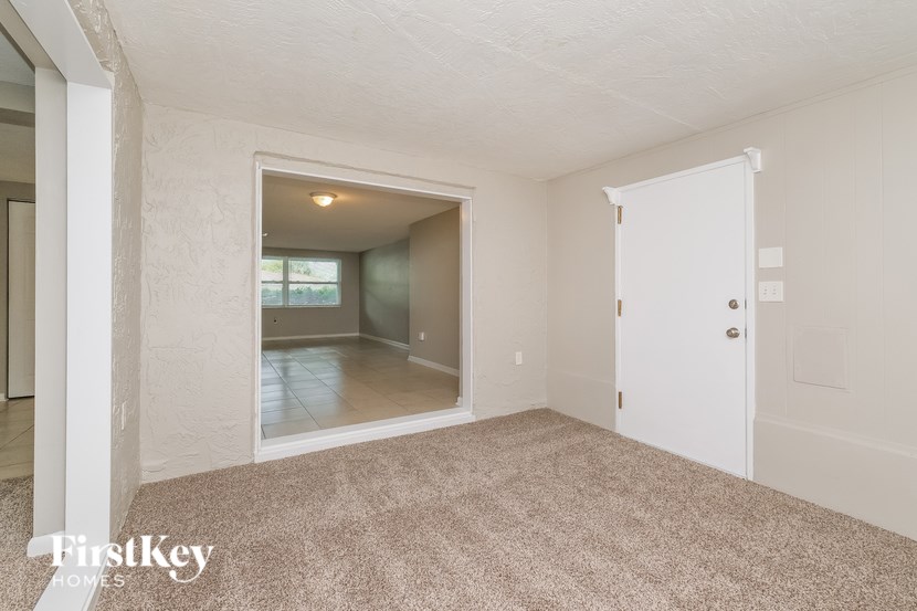 A room with a white door and a window.