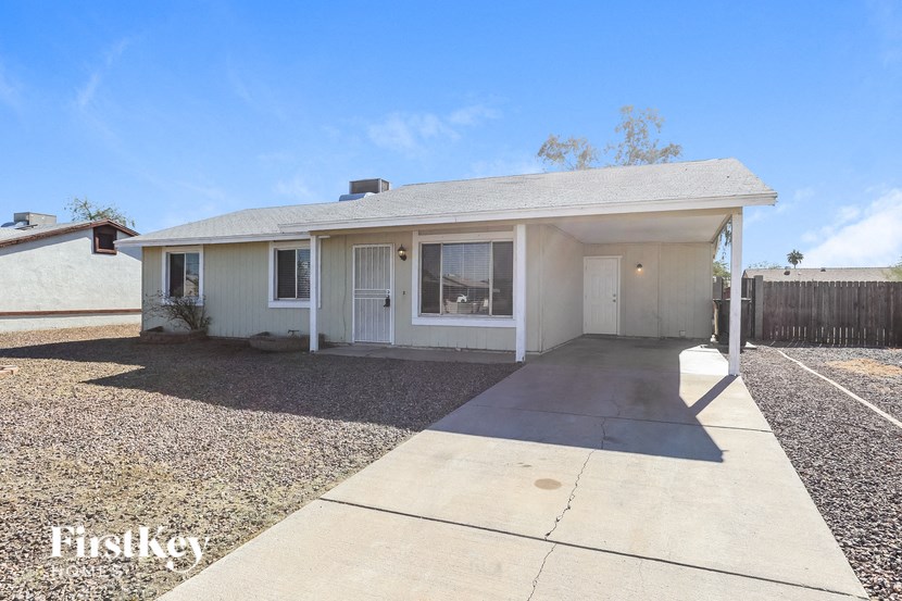 a white house with a driveway and a white door