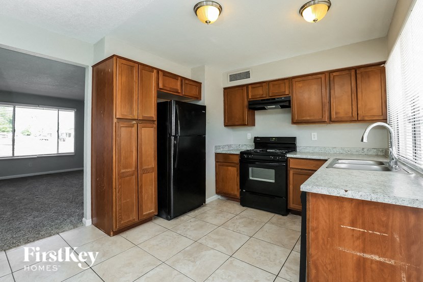 a kitchen with black appliances and wooden cabinets