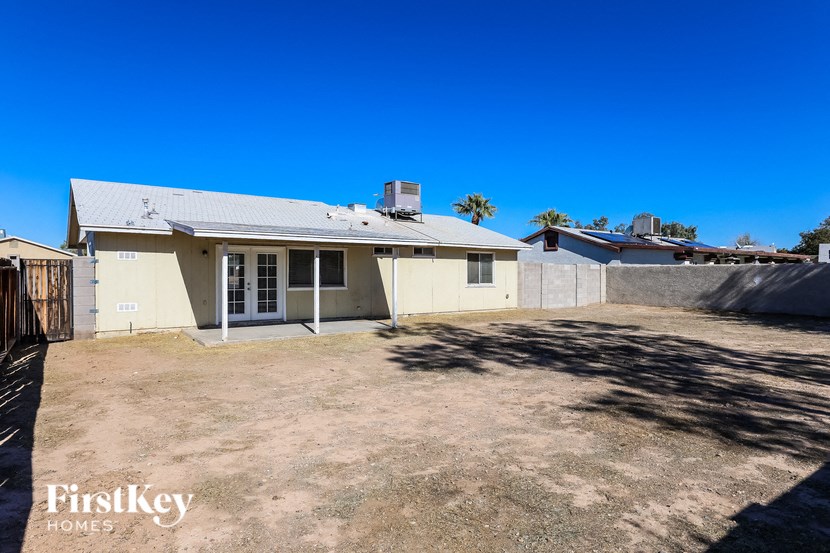 a white house with a yard and a fence