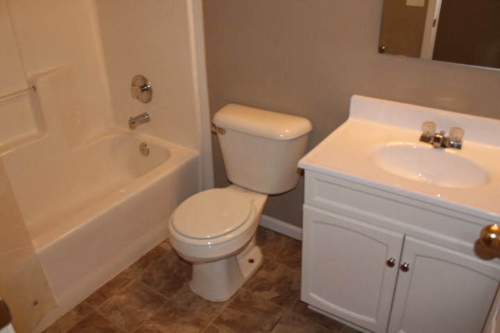a bathroom with a toilet and a sink and a tub