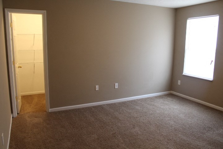 an empty room with a door and a window