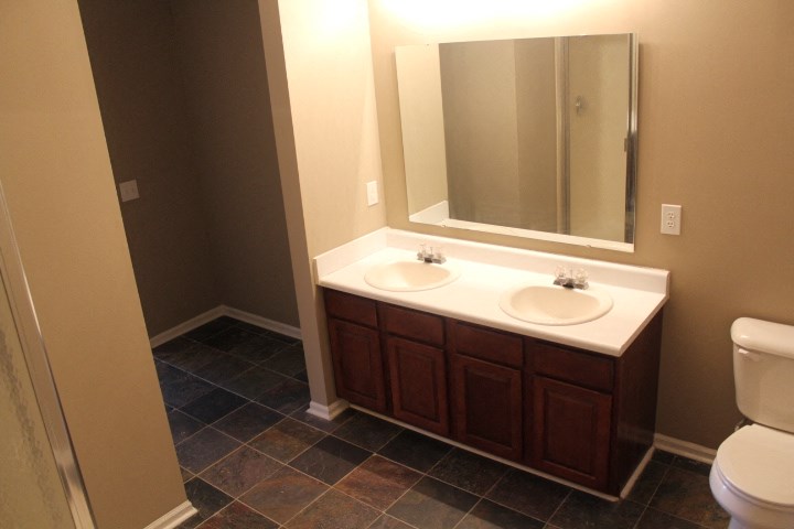 a bathroom with two sinks and a mirror