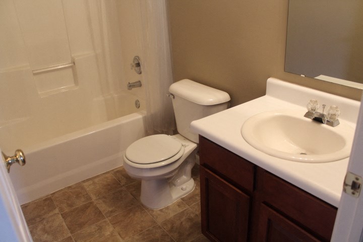 a bathroom with a toilet and a sink and a bath tub