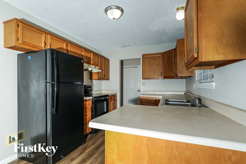 a kitchen with black appliances and wooden cabinets