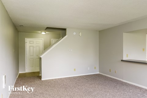 A room with a staircase leading to another room.