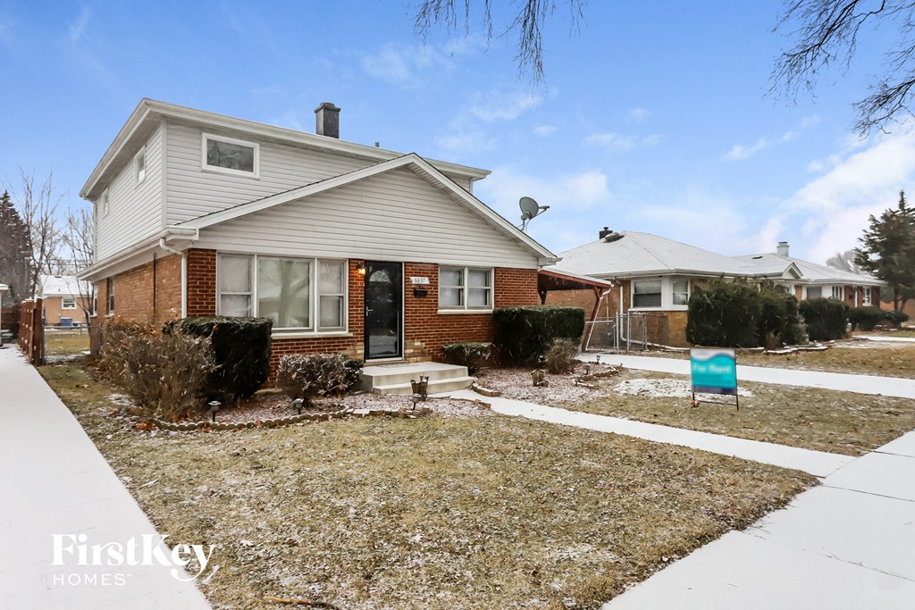 a white house with a yard and a blue mailbox