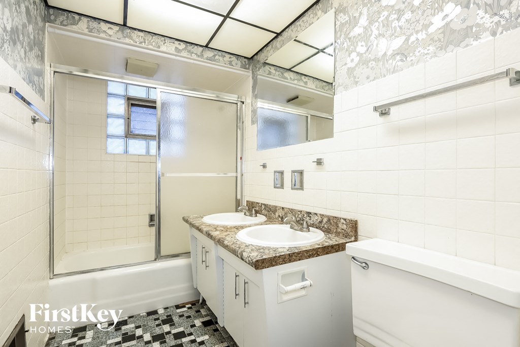 a bathroom with a sink and a shower and a tub