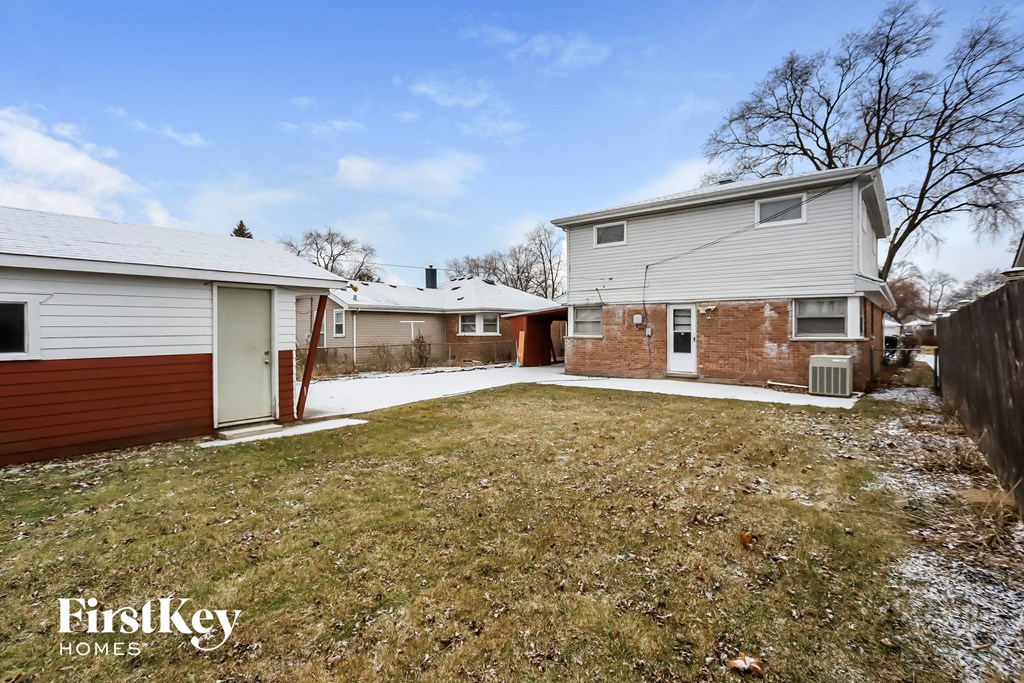 a yard in front of a house with snow on the ground