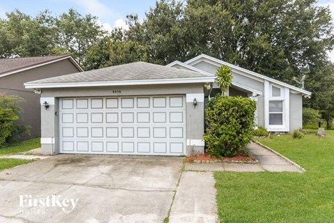 a white garage door in front of a house