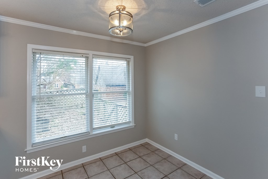 A room with a window and a light fixture.
