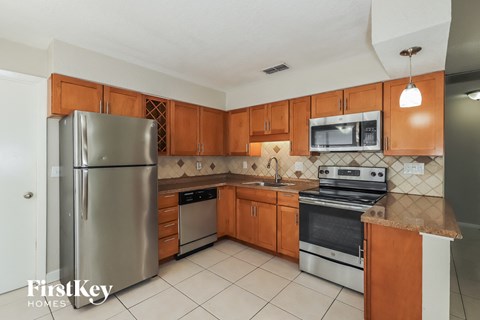 A kitchen with wooden cabinets and stainless steel appliances.