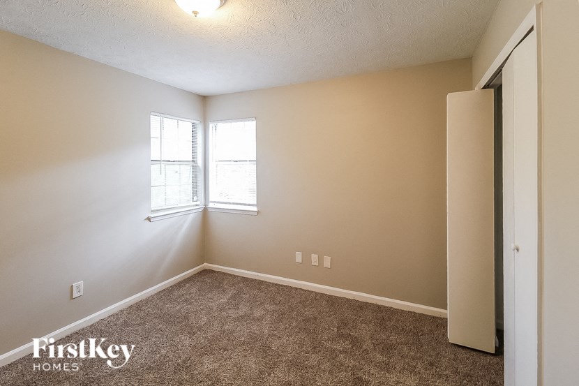 a bedroom with a closet and a window