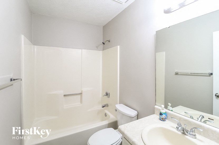 a bathroom with a sink toilet and a bath tub