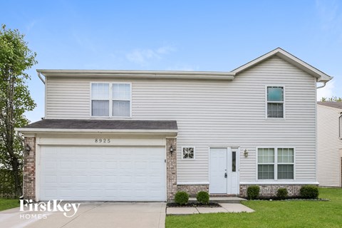 a white house with a white garage door